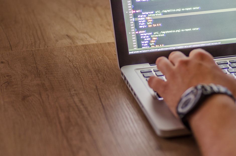 developer writing code at computer