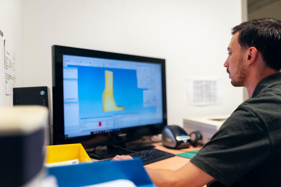 game developer working on computer with 3D software