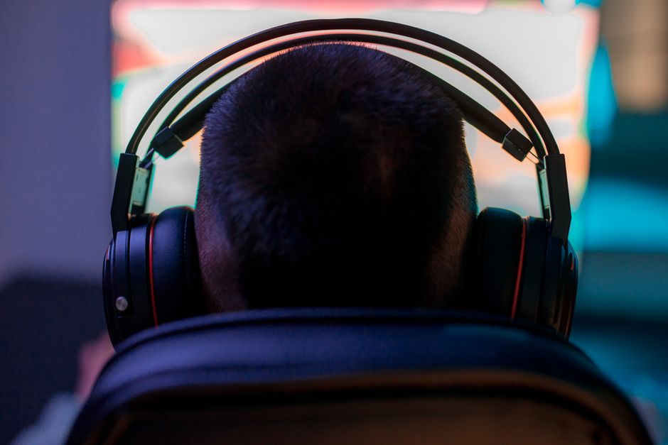 person wearing headphones gaming