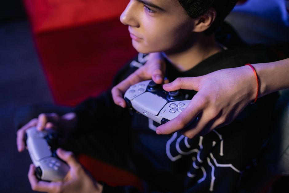 gamer playing video game controller focus